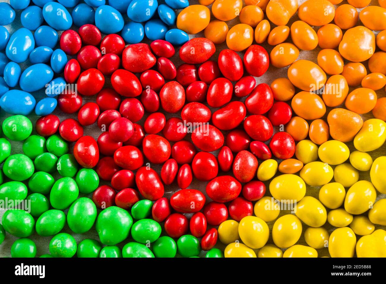 M&M's candy on the yellow background, colorful candy and multicolored ...
