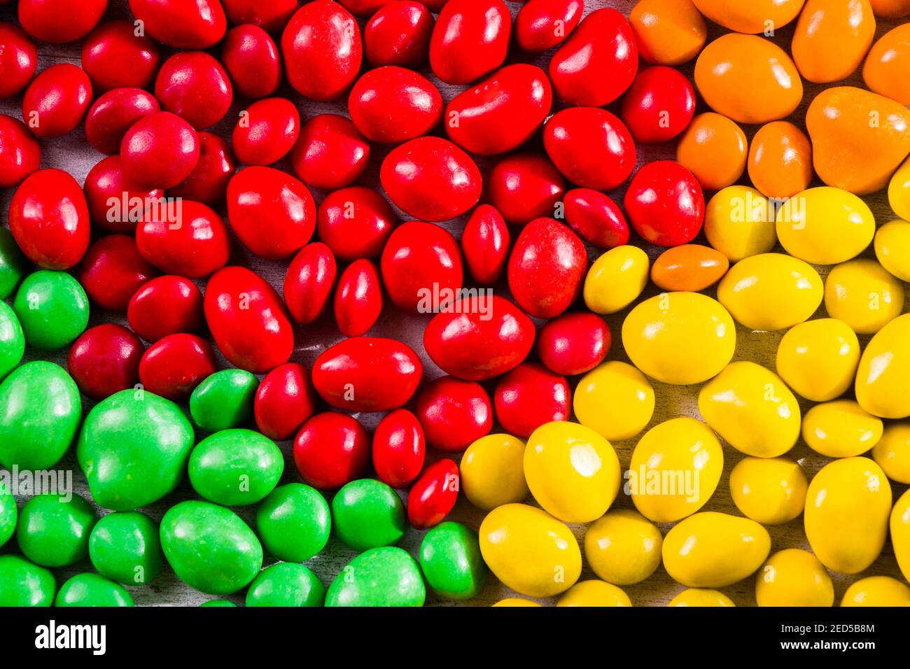 M&M's candy on the yellow background, colorful candy and multicolored ...