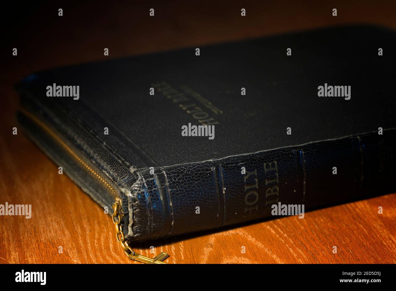 Close up photo of a zippered version of the King James Bible lying on an oak table. Stock Photo