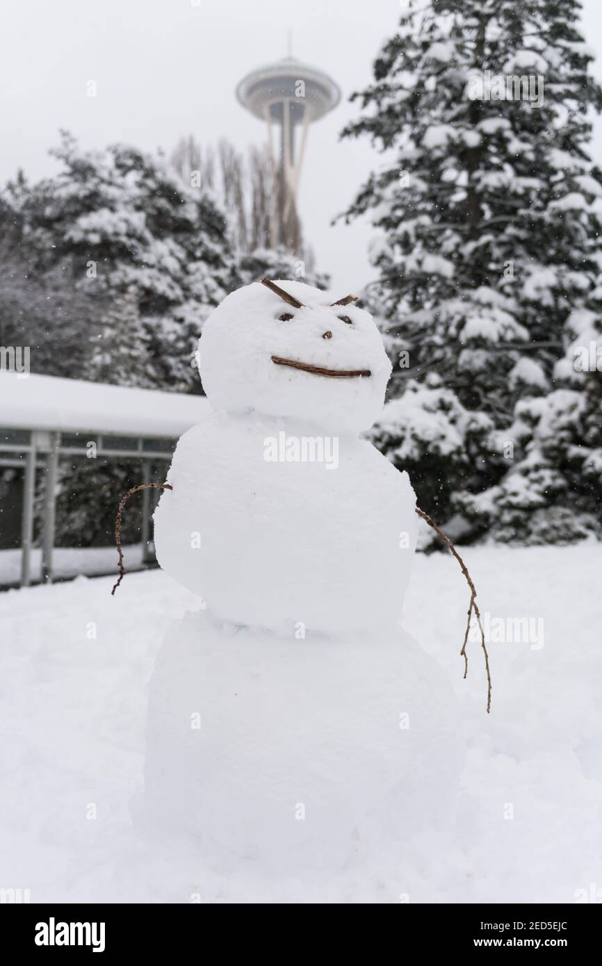 Seattle, USA. 13th Feb, 2021. Mid-day an angry Snowman at the Seattle Center in the snow. Stock Photo