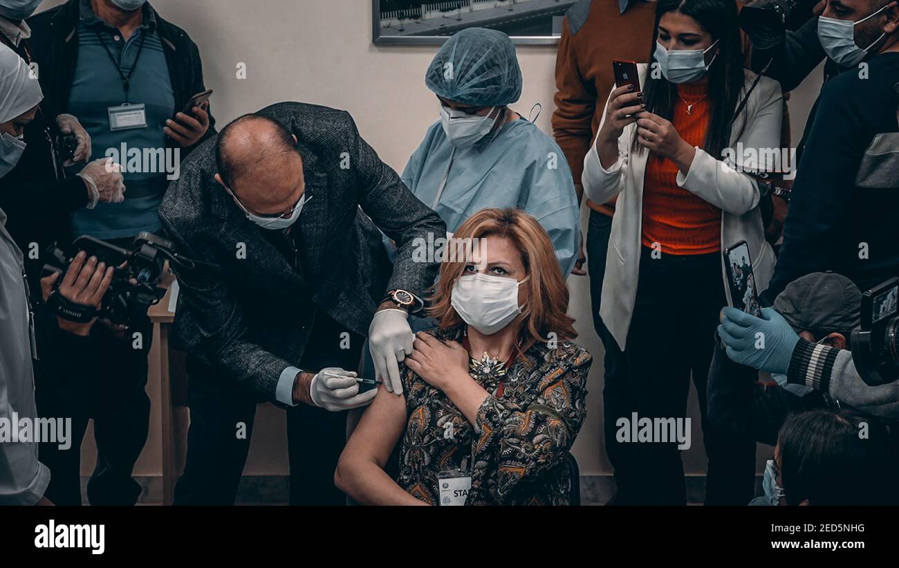 Lebanese Minister of Public Health Hamad Hassan vaccinating First Lebanese Citizen woman for Covid 19 Coronavirus Pfizer vaccine Stock Photo