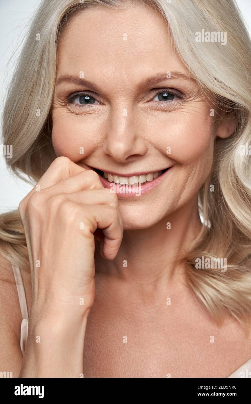 Happy middle aged woman looking at camera. Anti age face skin care, closeup view Stock Photo