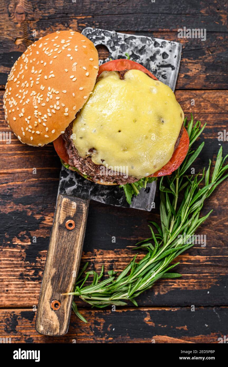 Grilled homemade burger with beef, tomato, cheese, cucumber and lettuce