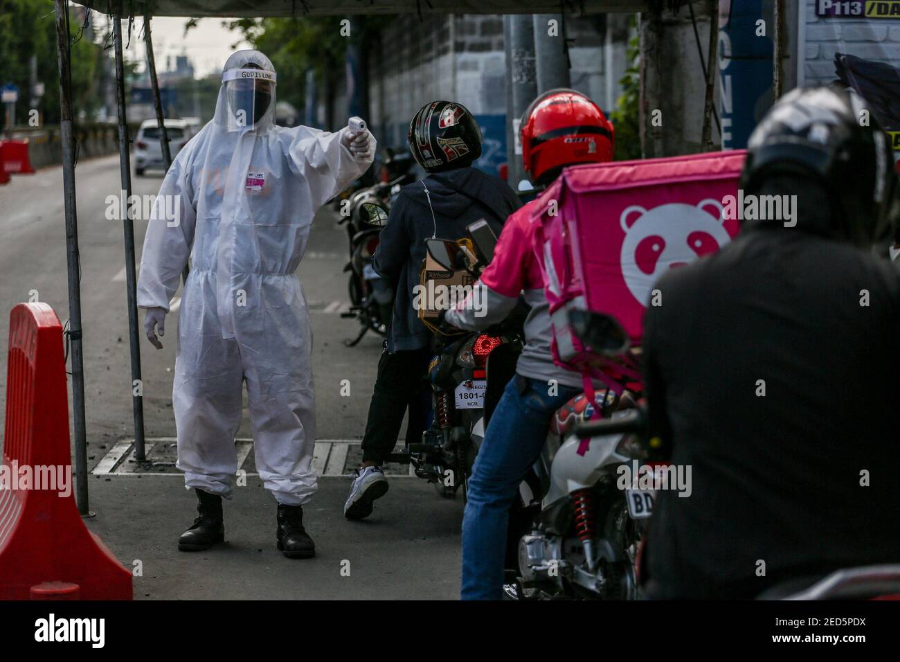 A Filipino soldier wearing personal protective equipment (PPE) checks