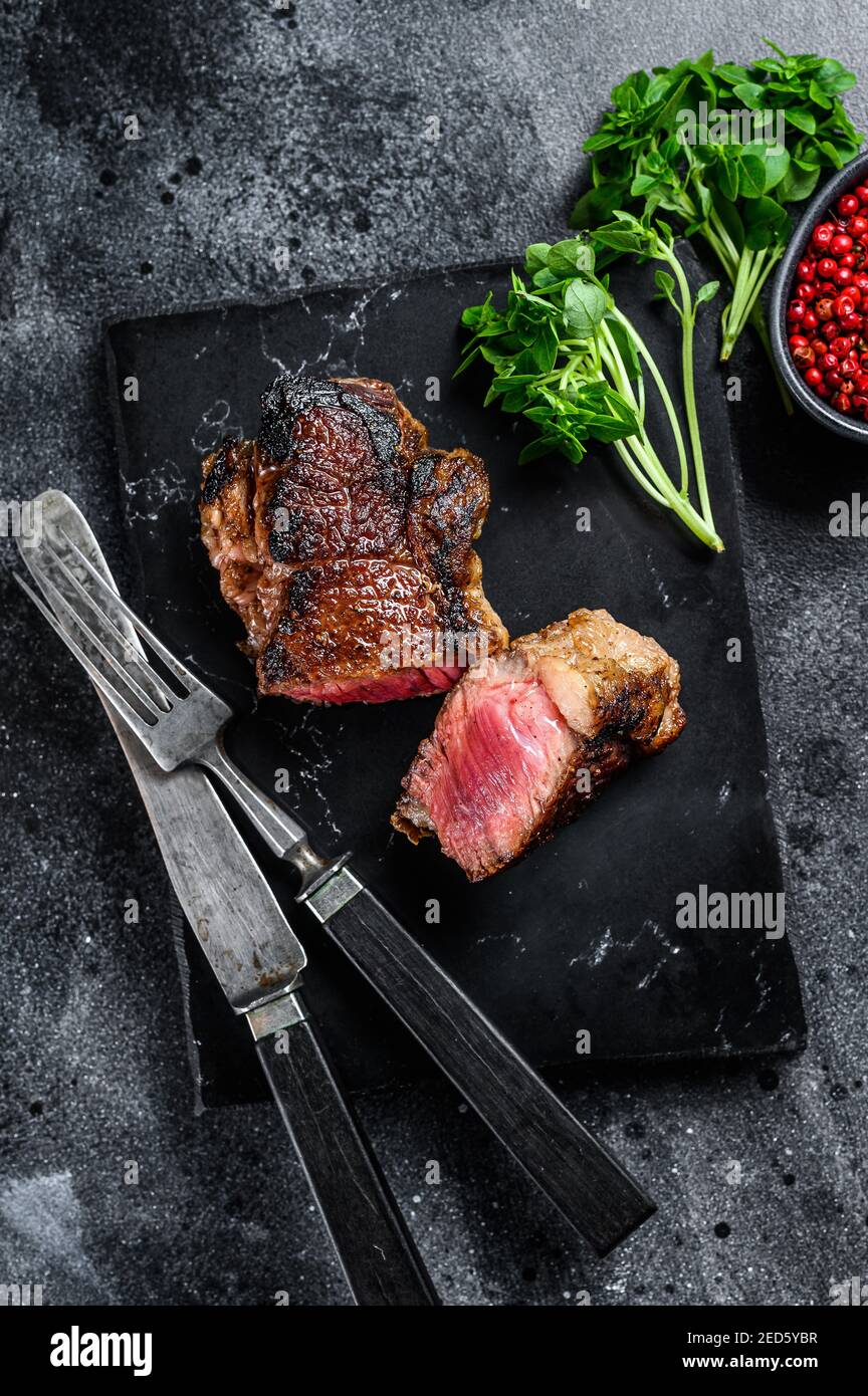 Grilled rump marble Beef steak. Black background. Top view Stock Photo