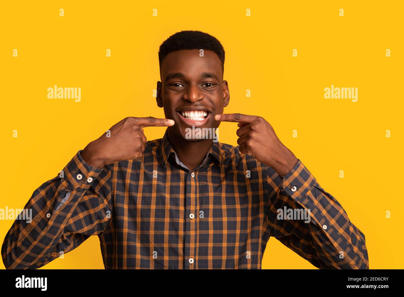 Perfect Smile. Happy Black Guy Pointing At His White Teeth With Fingers Stock Photo