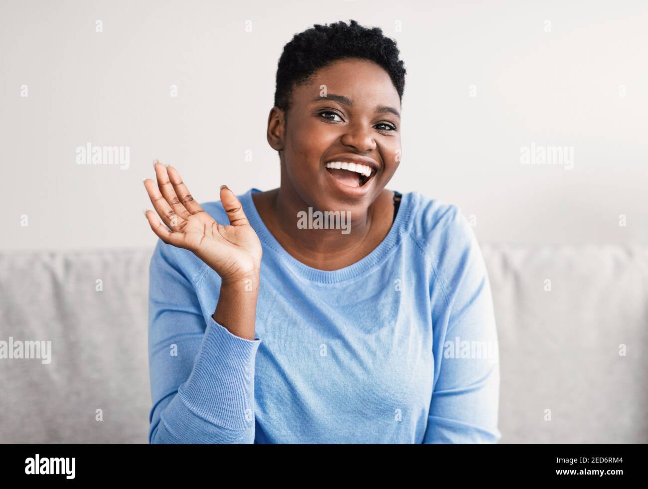 Portrait of casual young black woman laughing Stock Photo - Alamy
