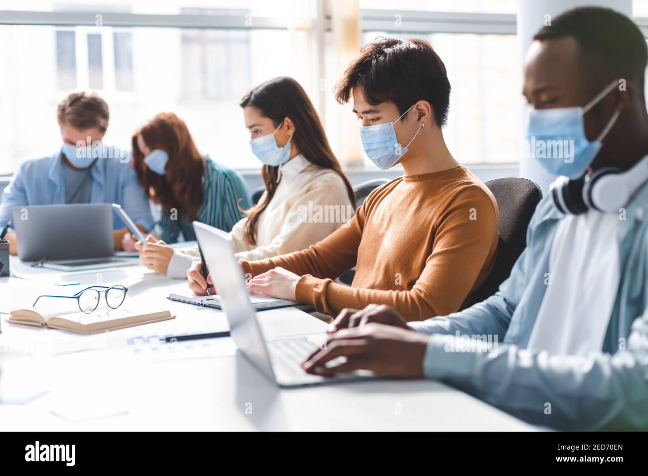 International people wearing medical face masks using laptop Stock ...