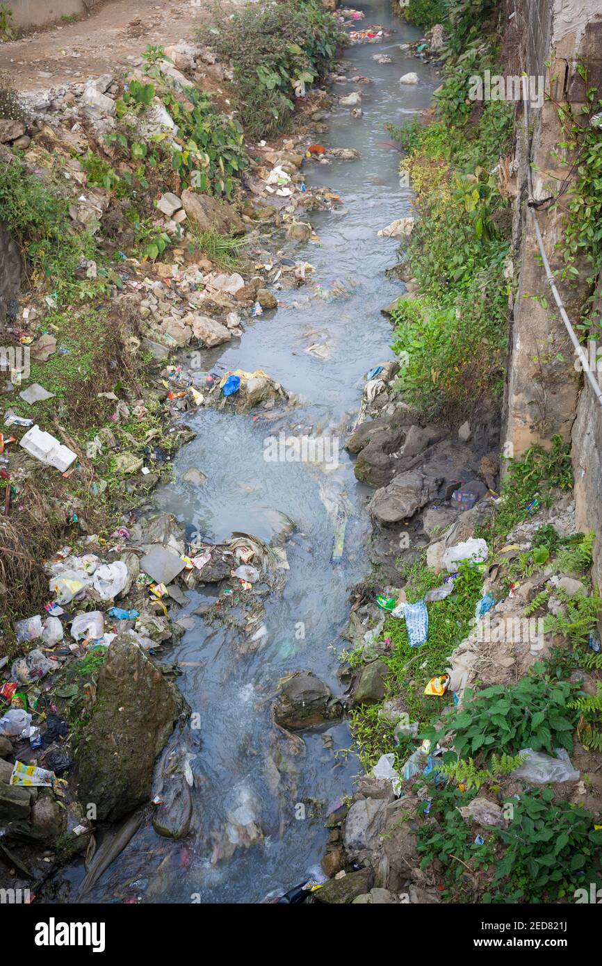 Small canalised river full of garbage. Pokhara. Nepal. Stock Photo