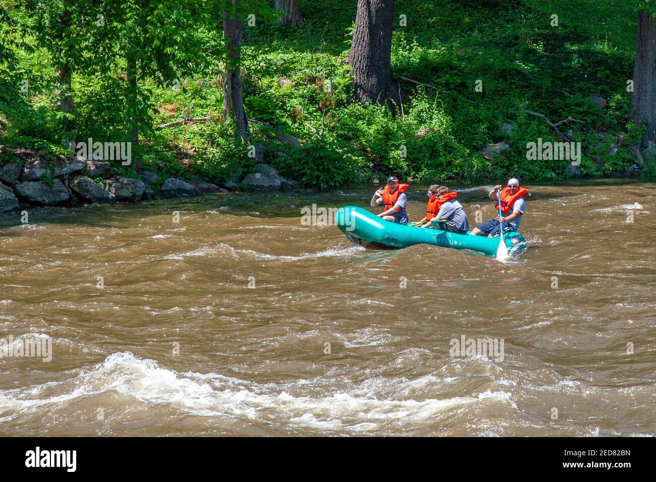 A boat traveling on the rough Housatonic River in West Cornwall, Connecticut Stock Photo