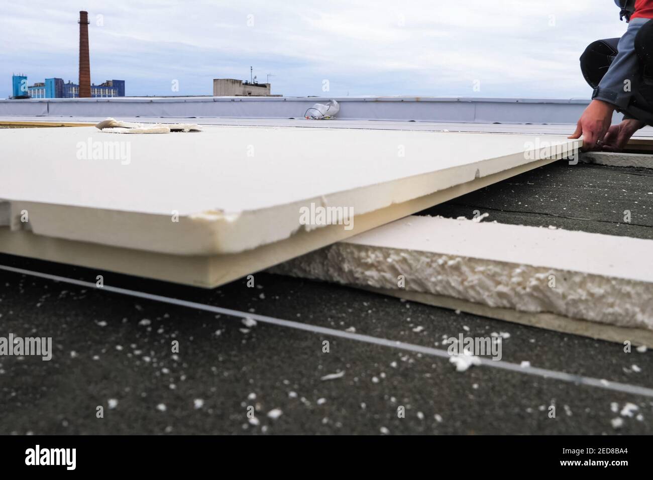 Roofing insulation, installation of insulation sheets on foam. Foam and insulation Stock Photo