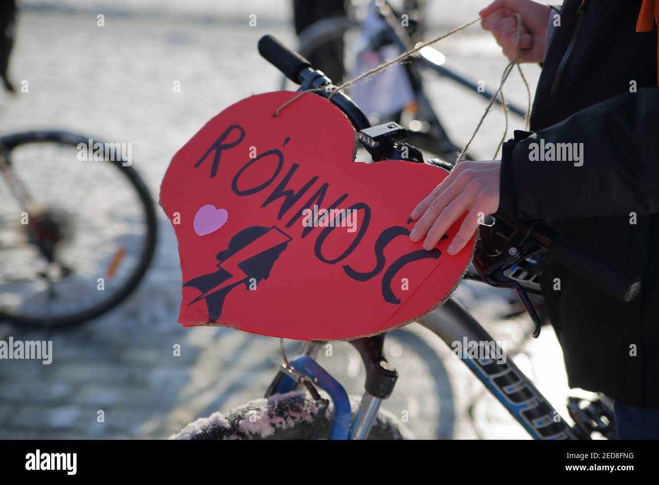 Read heart with word EQUALITY in Polish, symbols of Women Strike movement, decorate bicycle while protester support feminists rights in Poland Stock Photo
