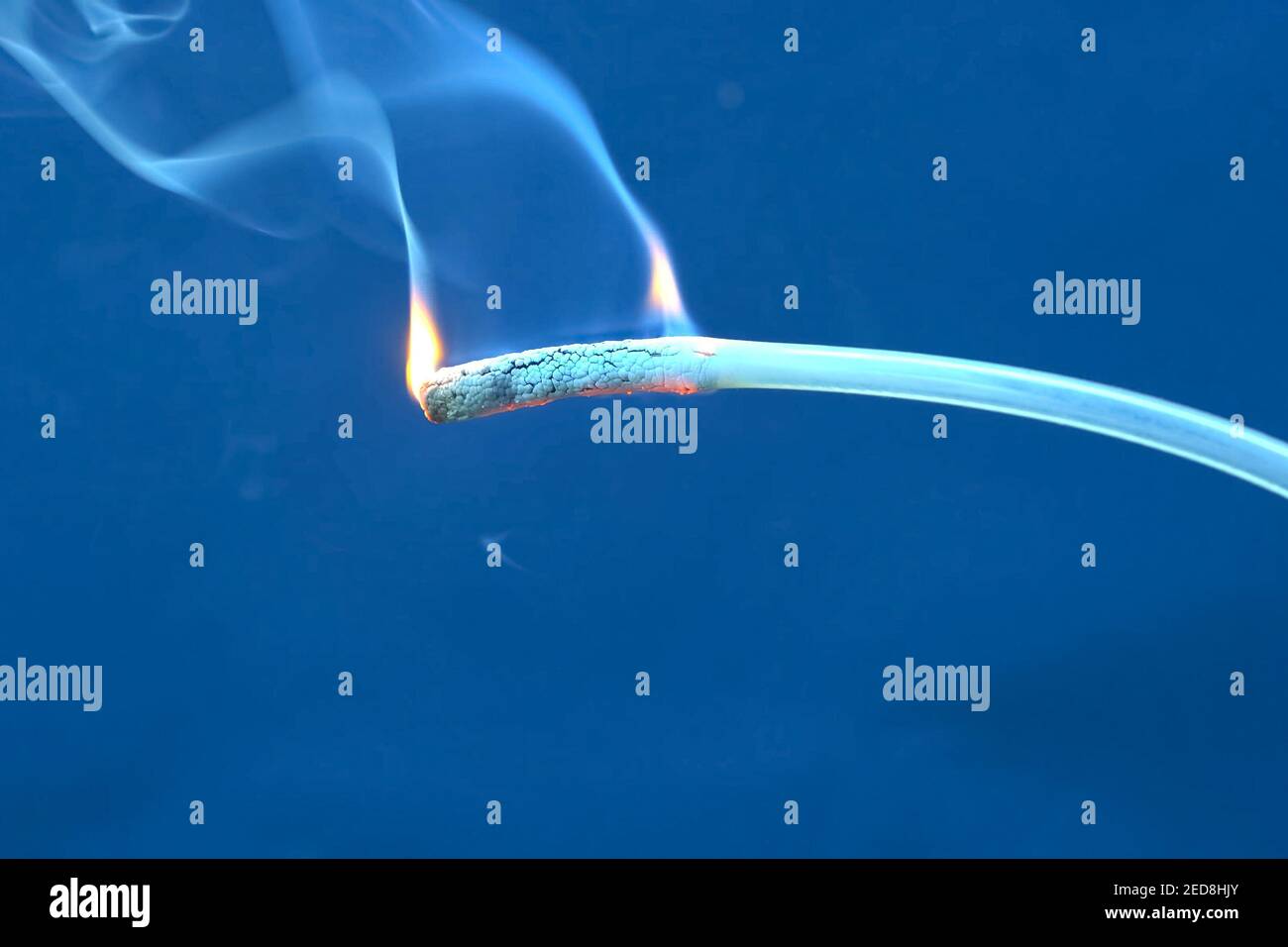 Burning hot glue for heat gun. Flames and smoke of burning plastic