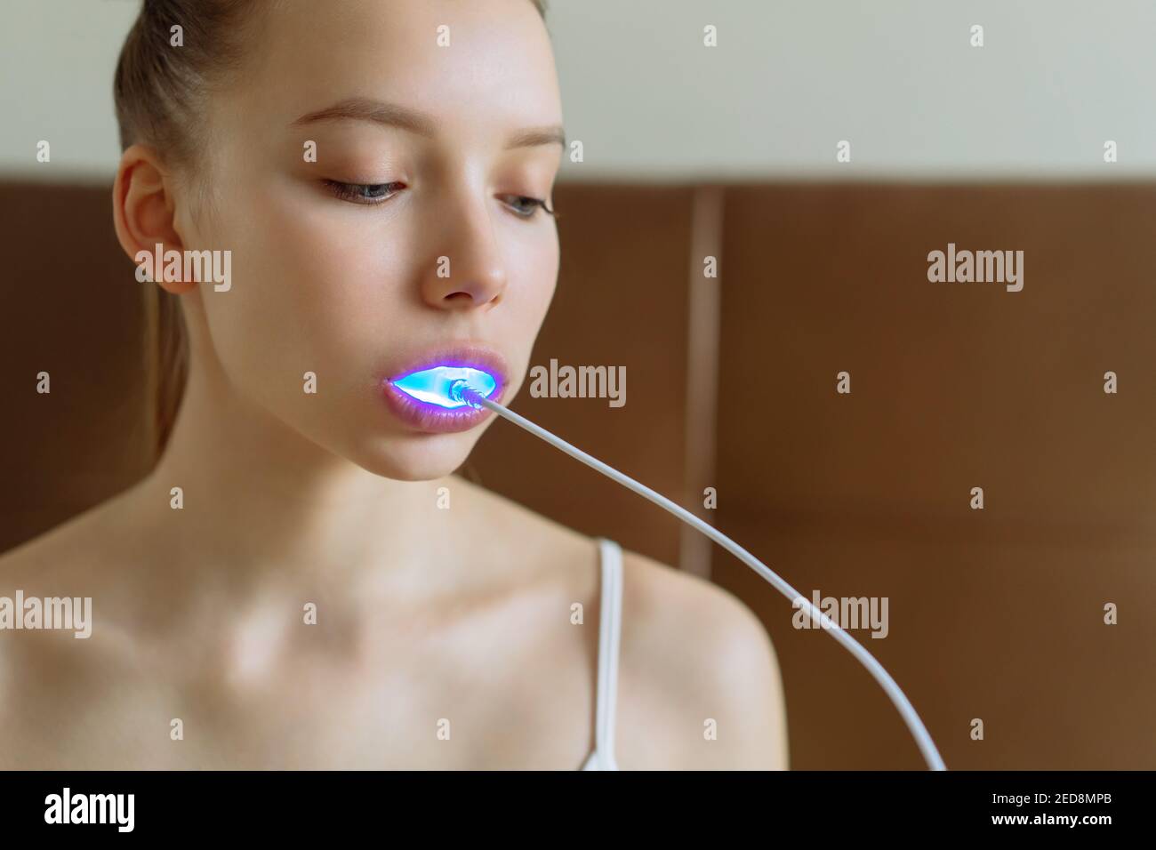 A young girl is engaged in home teeth whitening. Stock Photo