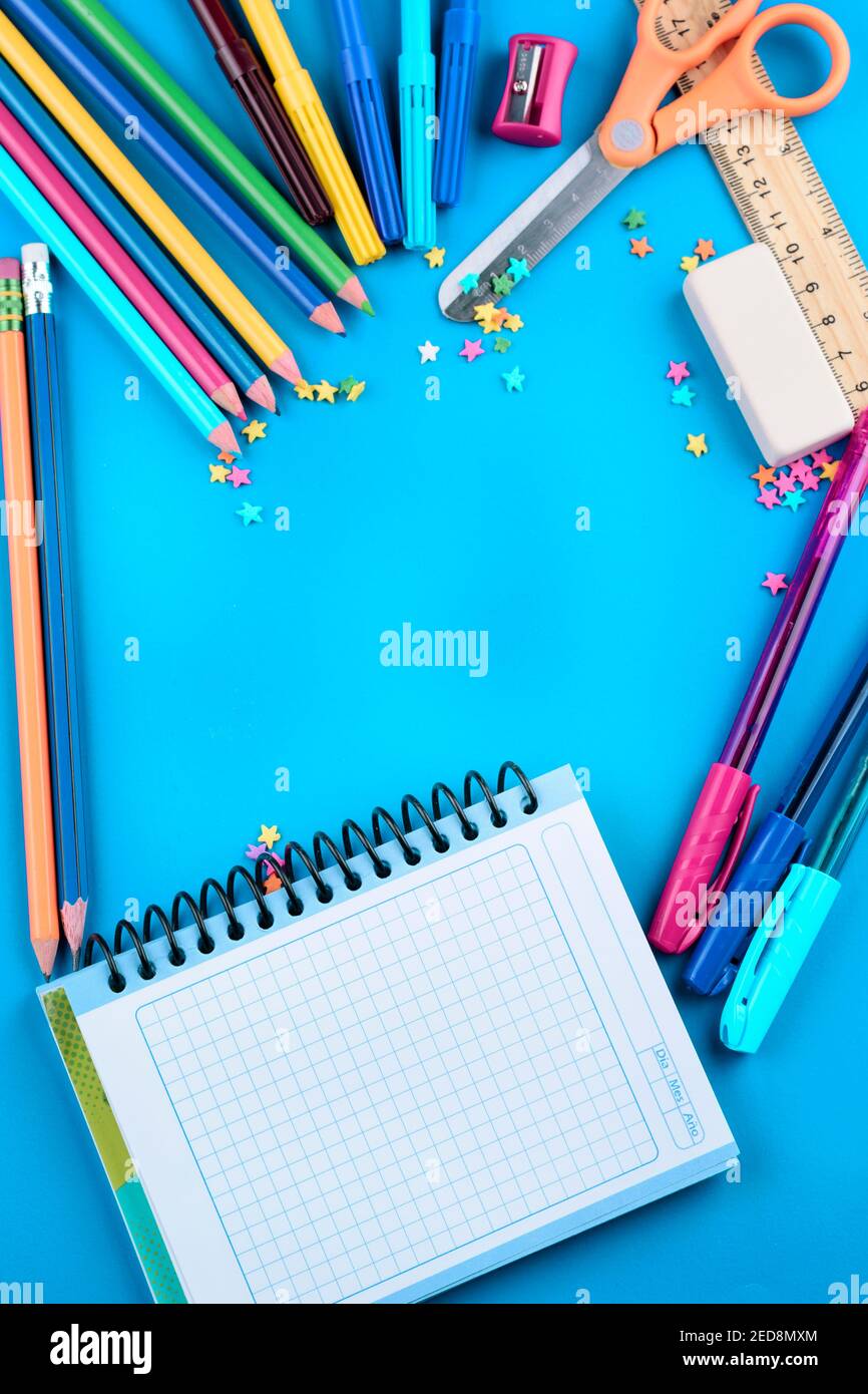 colorful school objects, ruler scissors, colors, on bright blue background Stock Photo