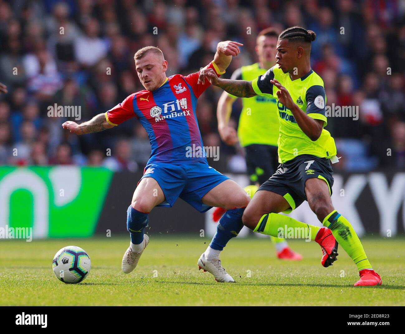 Soccer Football - Premier League - Crystal Palace v Huddersfield Town - Selhurst Park, London, Britain - March 30, 2019  Crystal Palace's Max Meyer in action with Huddersfield Town's Juninho Bacuna     Action Images via Reuters/Andrew Couldridge  EDITORIAL USE ONLY. No use with unauthorized audio, video, data, fixture lists, club/league logos or 'live' services. Online in-match use limited to 75 images, no video emulation. No use in betting, games or single club/league/player publications.  Please contact your account representative for further details. Stock Photo