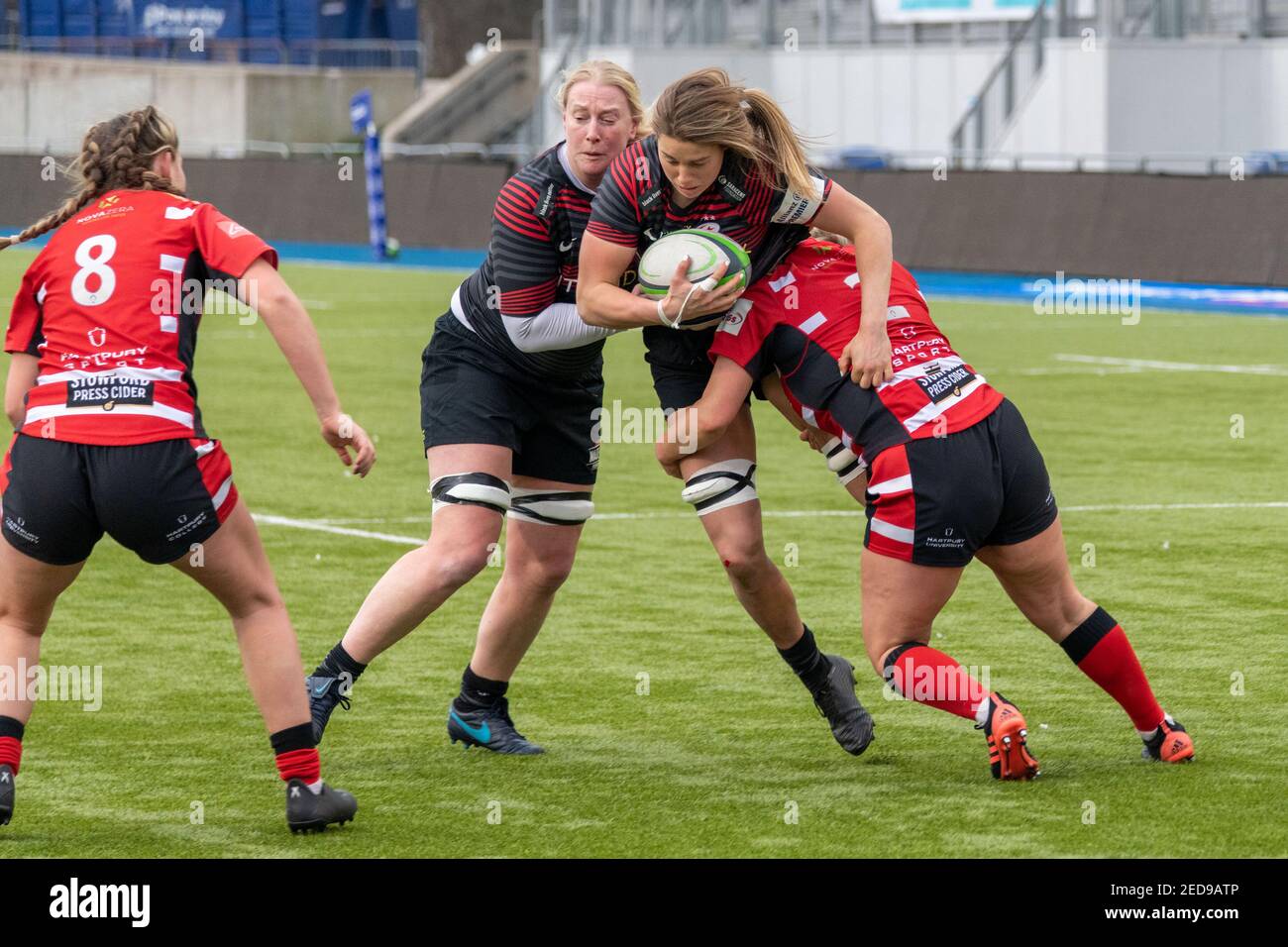 London, UK. 14th Feb, 2021. Sophie De Goede (#4 Saracens Women) being tackled by Kelsey Jones (#2 Gloucester-Hartpury Women) during the Allianz Premier 15s game between Saracens Women and Gloucester Hartpury Women at StoneX Stadium in London, England. Credit: SPP Sport Press Photo. /Alamy Live News Stock Photo