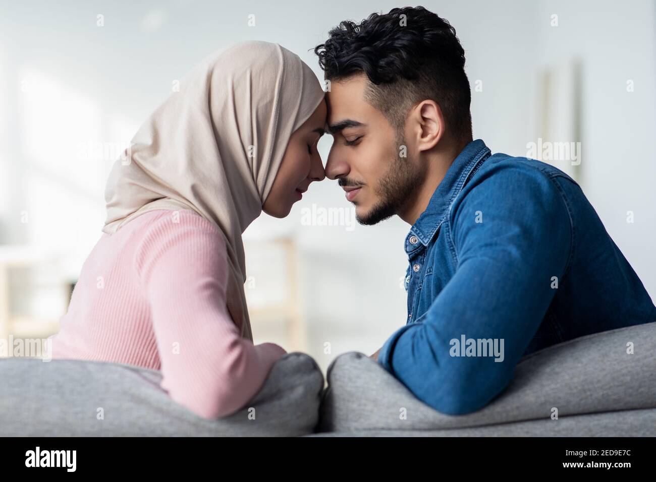 Closeup of loving muslim couple bonding at home Stock Photo - Alamy