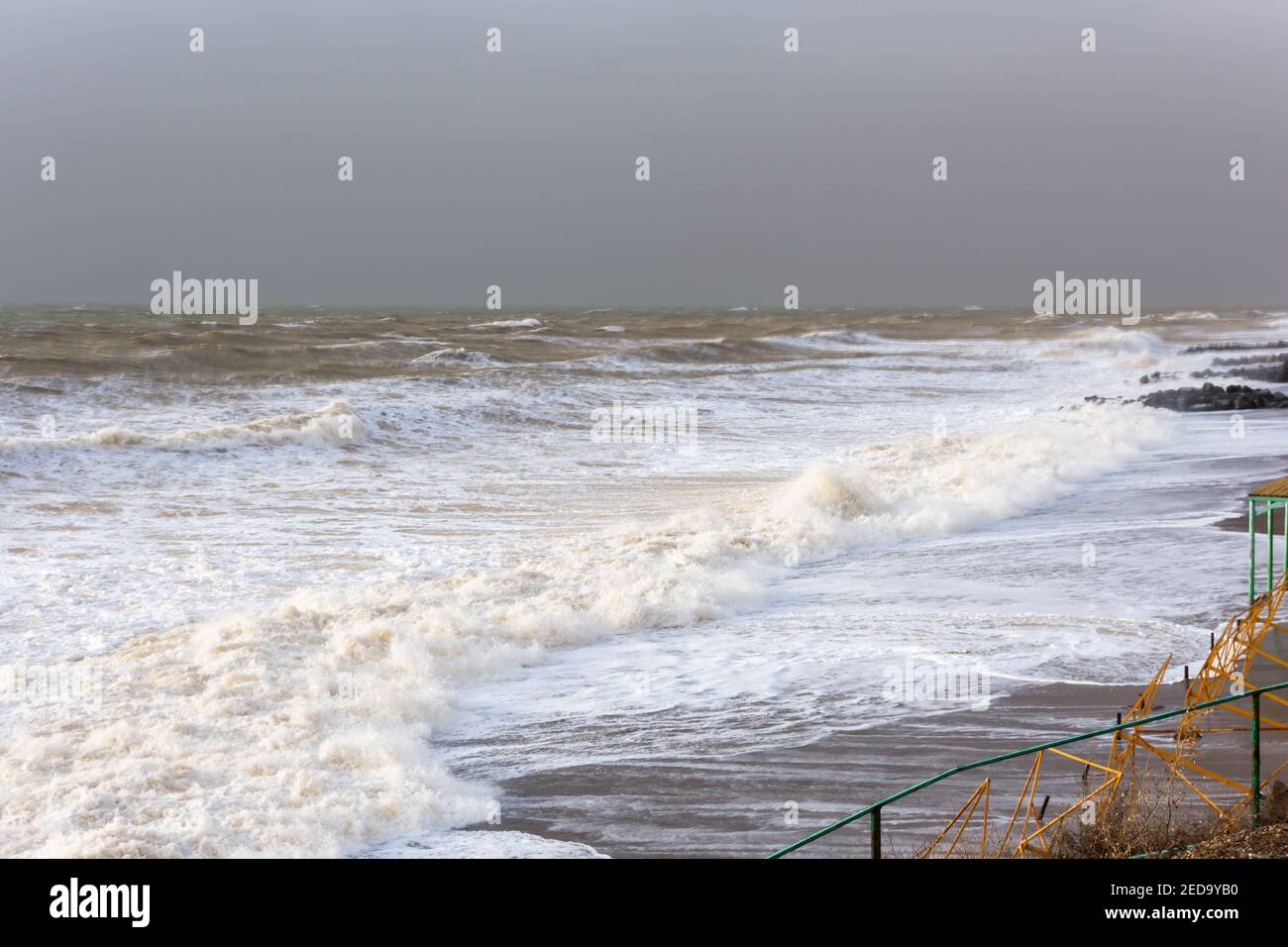 Storm sea sand beach is a neutral color. Natural background in beige shades. The raging elements, the majestic view of the sea surf. Foaming waves Stock Photo