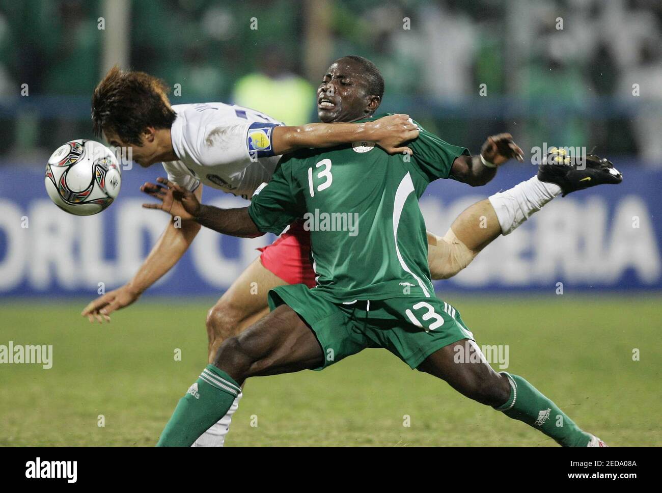 Football - Korea Republic v Nigeria FIFA Under 17 World Cup Quarter Final -  Nigeria 2009 - UJ Esuene Stadium, Calabar, Nigeria - 9/11/09 Korea's Jin Su  Kim (L) and Nigeria's Omoh