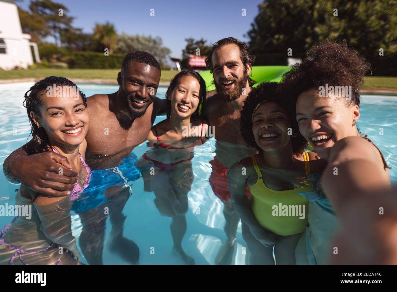 Portrait of diverse group of friends having fun in swimming pool