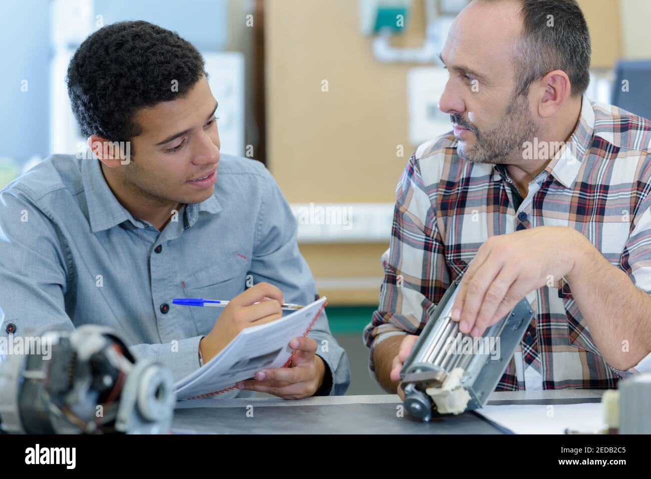 two male masters work in the workshop Stock Photo