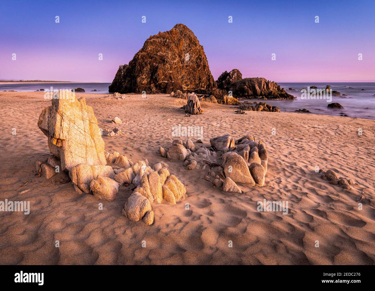 Playa Piedra Tlacoyunque with sunset glow on the rocks, Guerrero, Mexico. Stock Photo