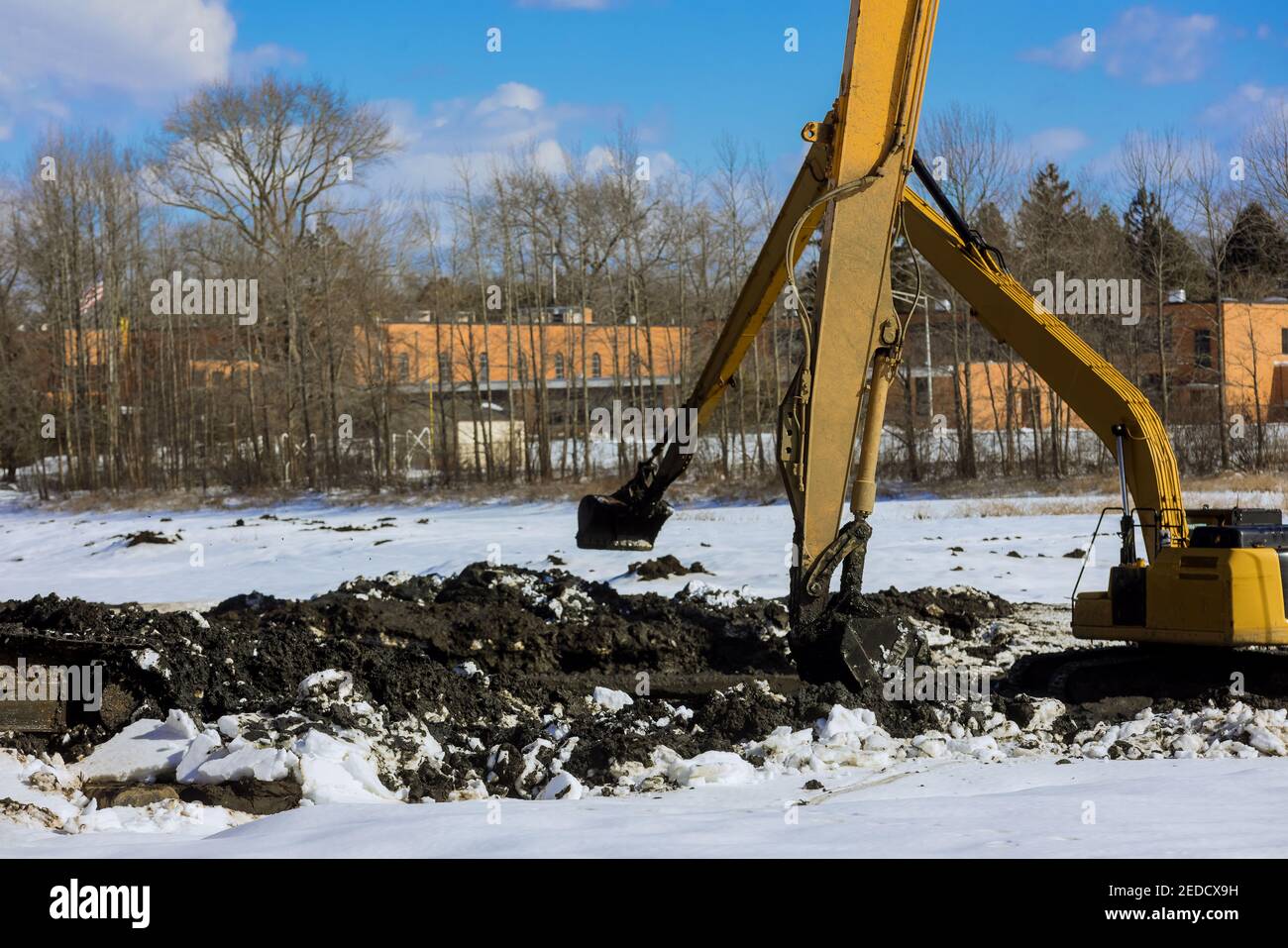 Excavators dredge and clean up a lake the winter snow of lake bottom Stock Photo Alamy
