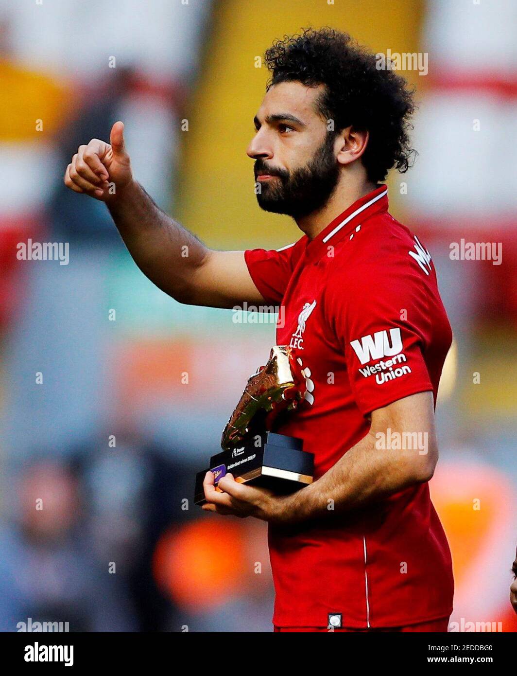 Soccer Football - Premier League - Liverpool v Wolverhampton Wanderers -  Anfield, Liverpool, Britain - May 12, 2019 Liverpool's Mohamed Salah  gestures to the fans as he holds a trophy for winning
