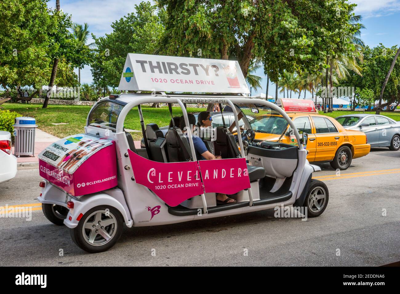 Tourist getting a free ride from a Freebee on Ocean Drive along South