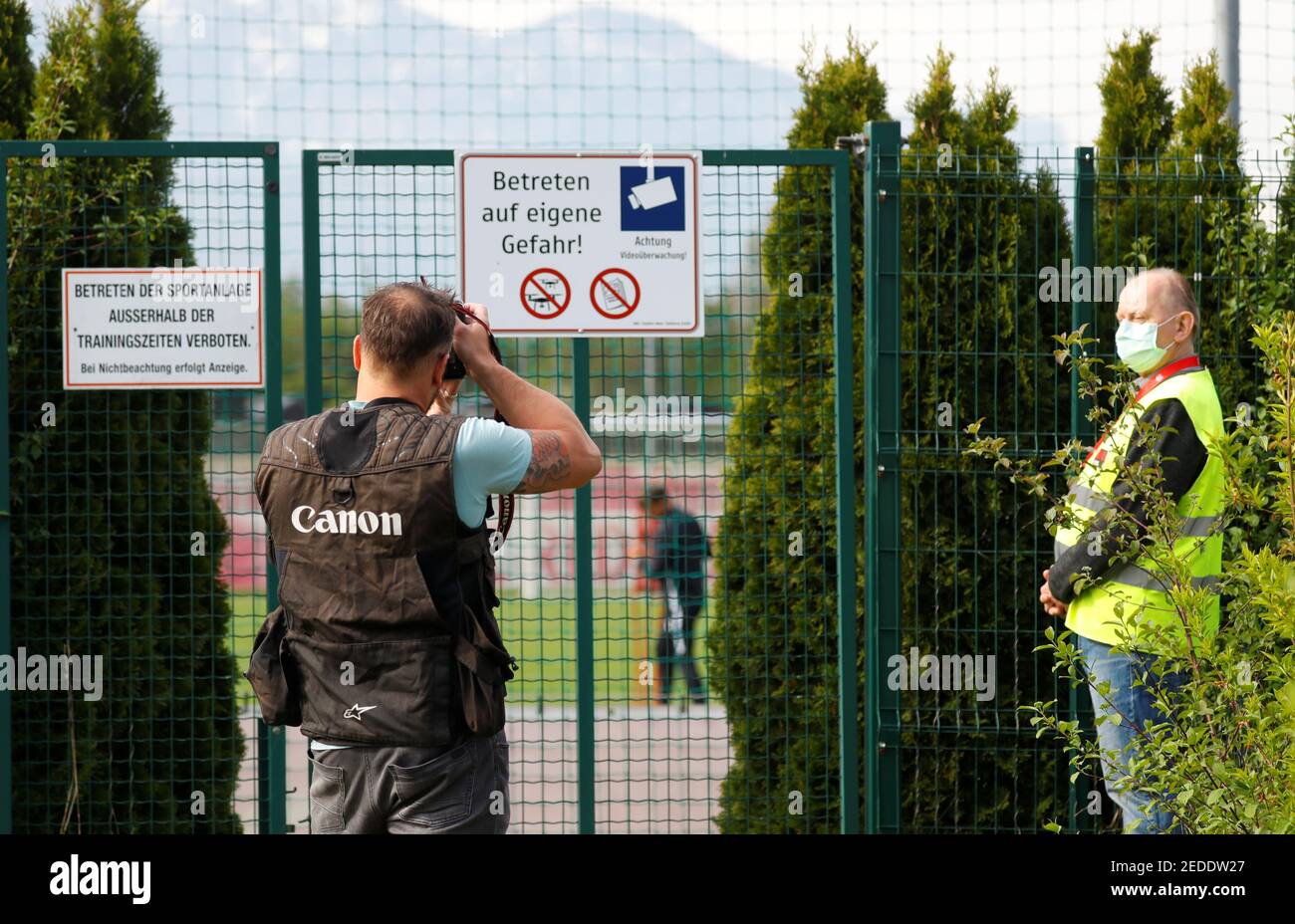 Soccer Football - Red Bull Salzburg Training - Red Bull Trainingszentrum, Salzburg, Austria - April 21, 2020 A security guard wearing a protective face mask outside the training session despite most sport being cancelled around the world as the spread of coronavirus disease (COVID19) continues. REUTERS/Leonhard Foeger Stock Photo