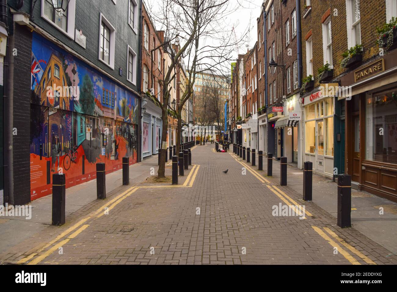 London, UK. 14th Feb, 2021. A deserted Neal Street in Covent Garden, London.As most businesses remain closed in the capital, the government plans to begin easing the lockdown restrictions in the coming weeks. Credit: SOPA Images Limited/Alamy Live News Stock Photo