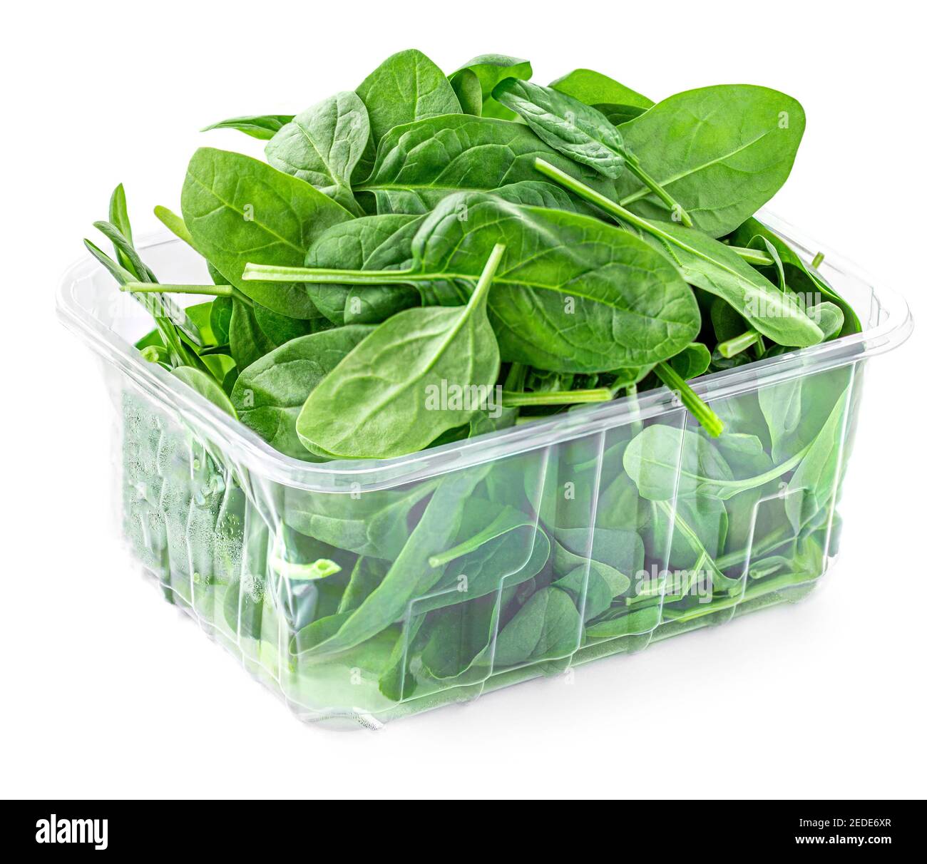 Spinach leaves in a plastic package isolated on white background. Green