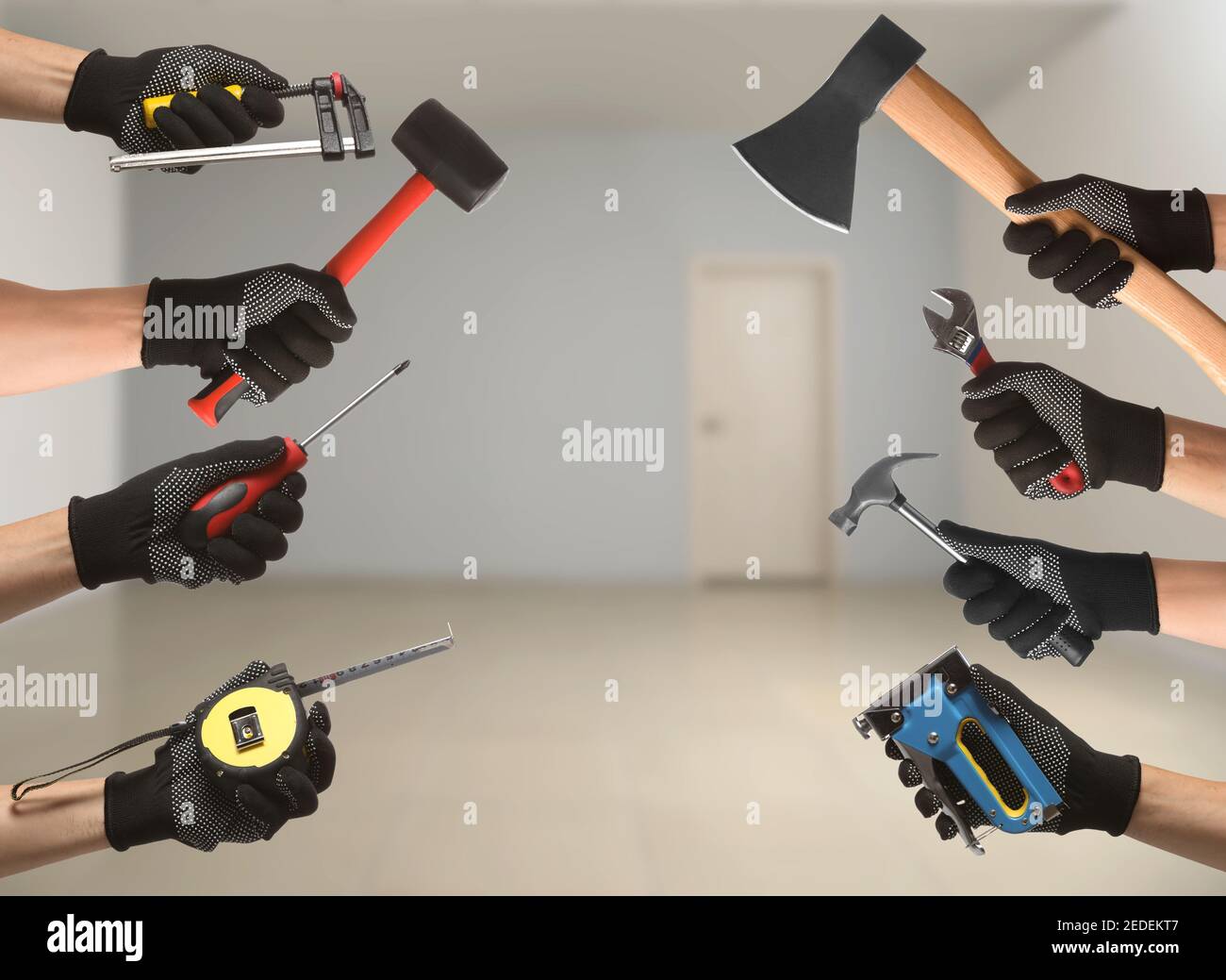 Many hands with different construction tools indoors Stock Photo