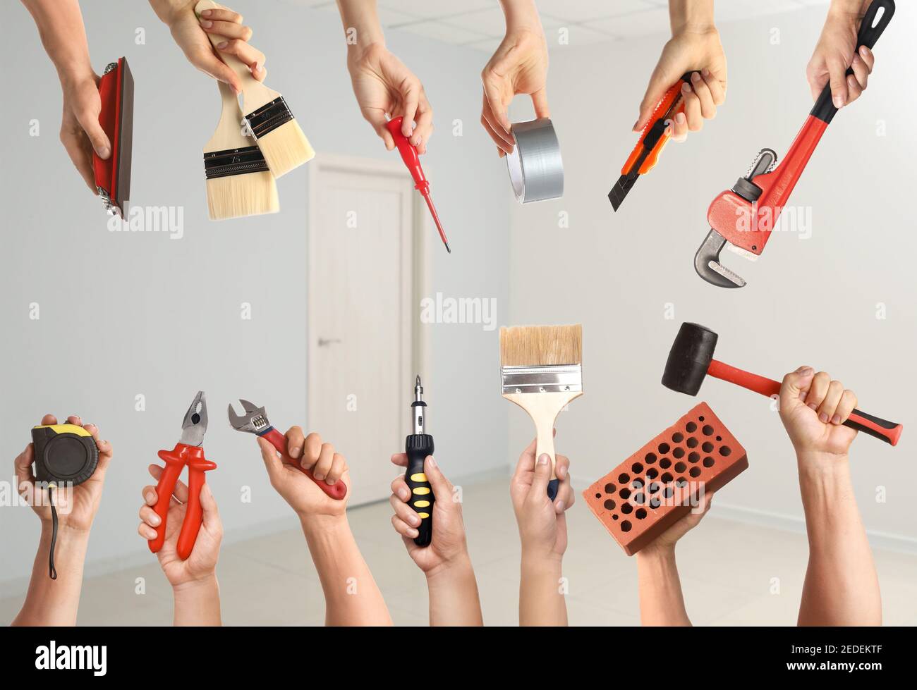 Many hands with different construction tools indoors Stock Photo Alamy