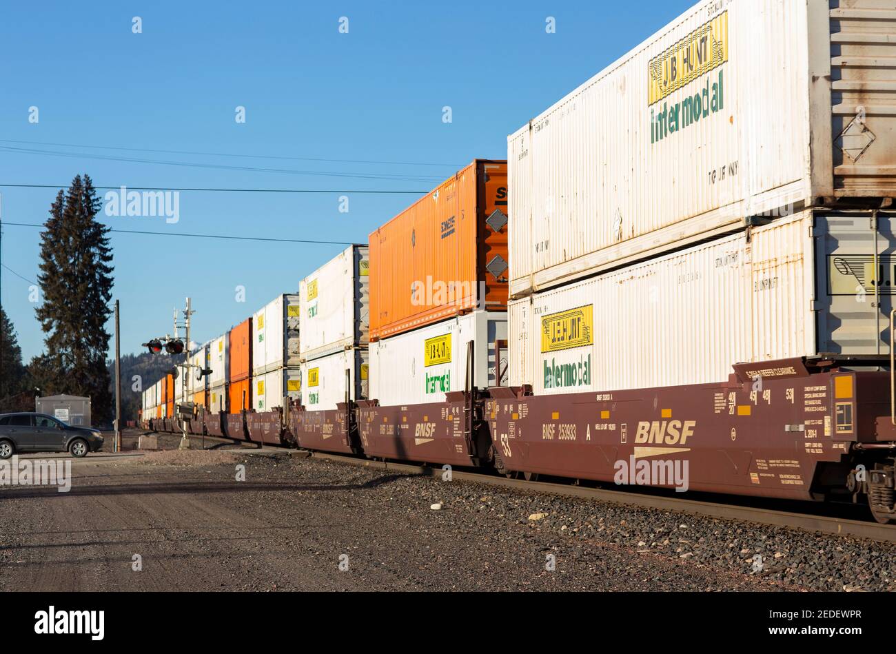 A line of container well cars through the BNSF rail yard in Troy, Montana.   Burlington Northern and Santa Fe Railway was formed in 1996, when the Bur Stock Photo