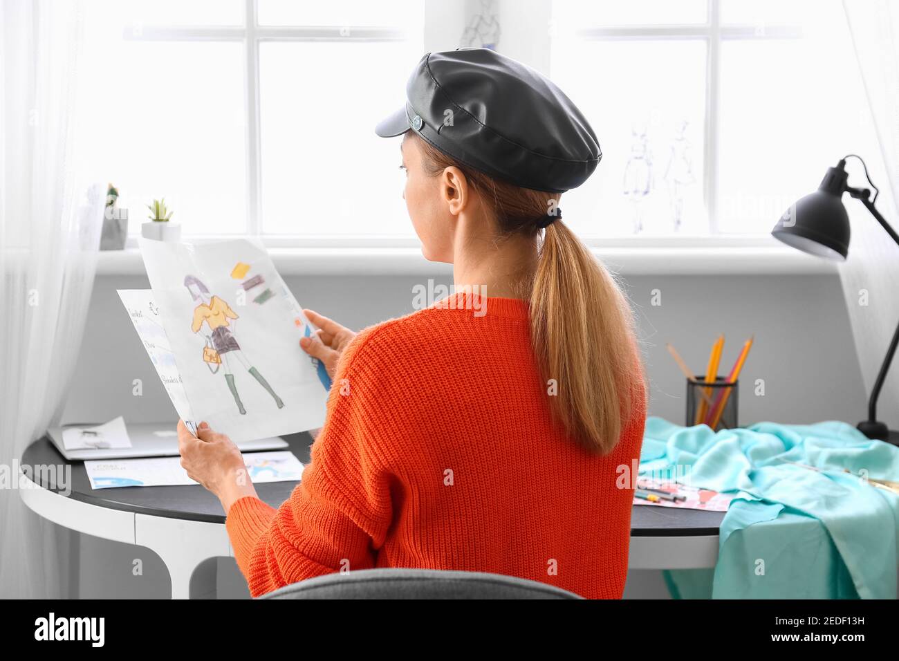 Female fashion designer working in studio Stock Photo - Alamy