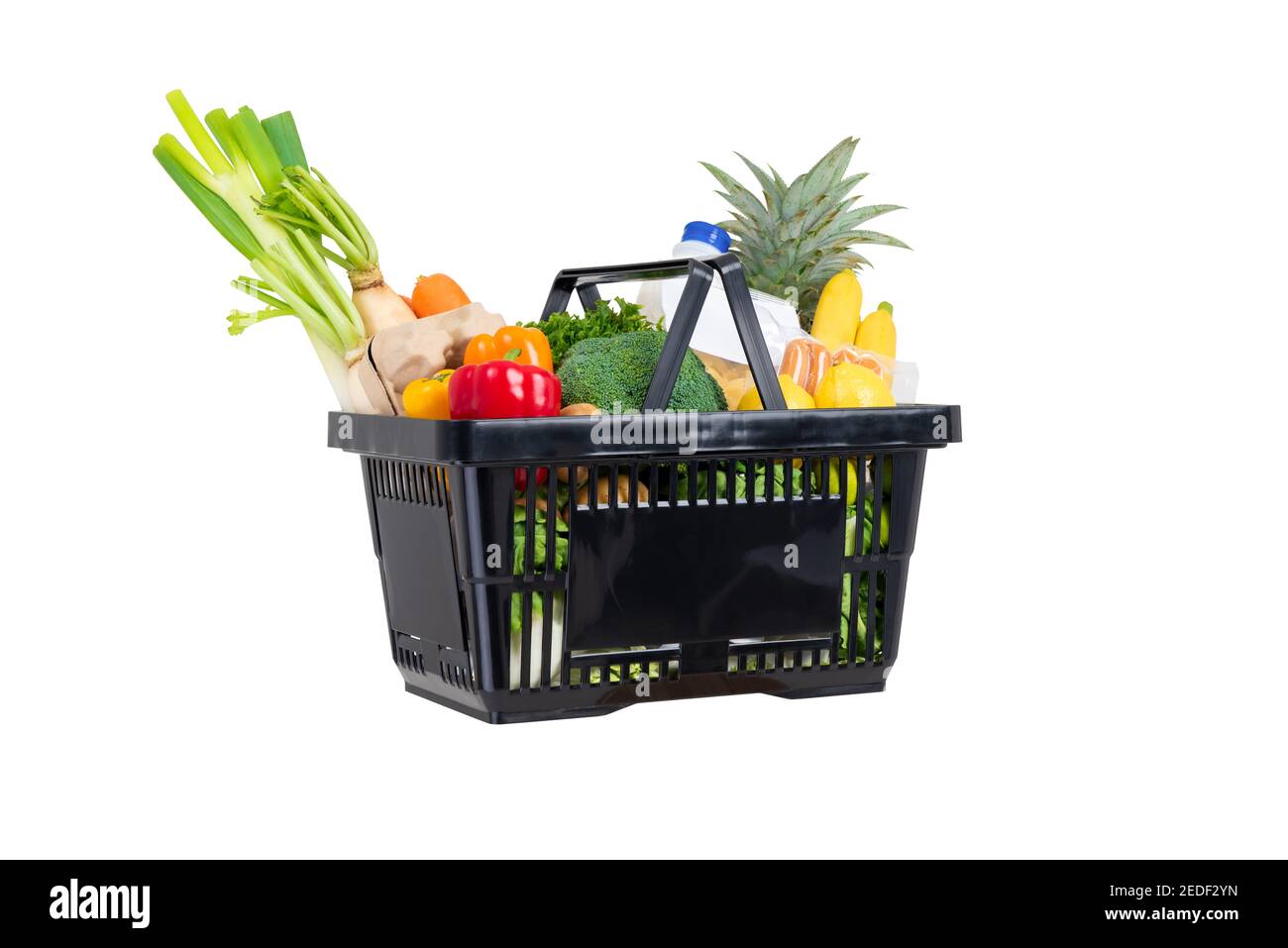 Black plastic shopping basket full of groceries and vegetables isolated on white background Stock Photo