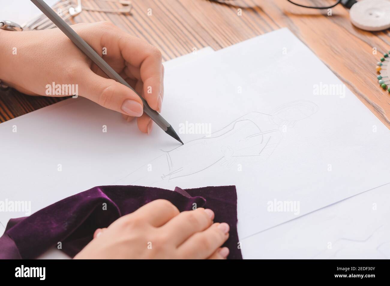 Female fashion designer working with sketch in studio, closeup Stock ...