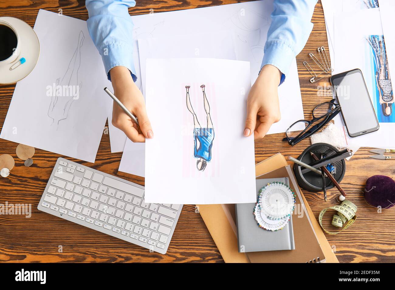 Female fashion designer working with sketches in studio, closeup Stock ...
