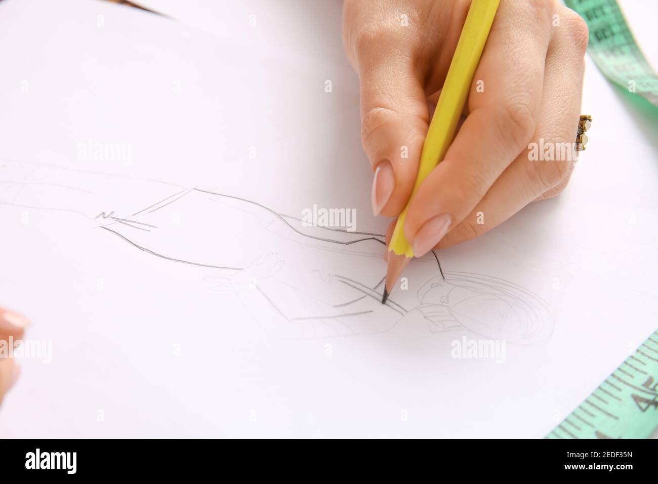 Female fashion designer working with sketch in studio, closeup Stock ...