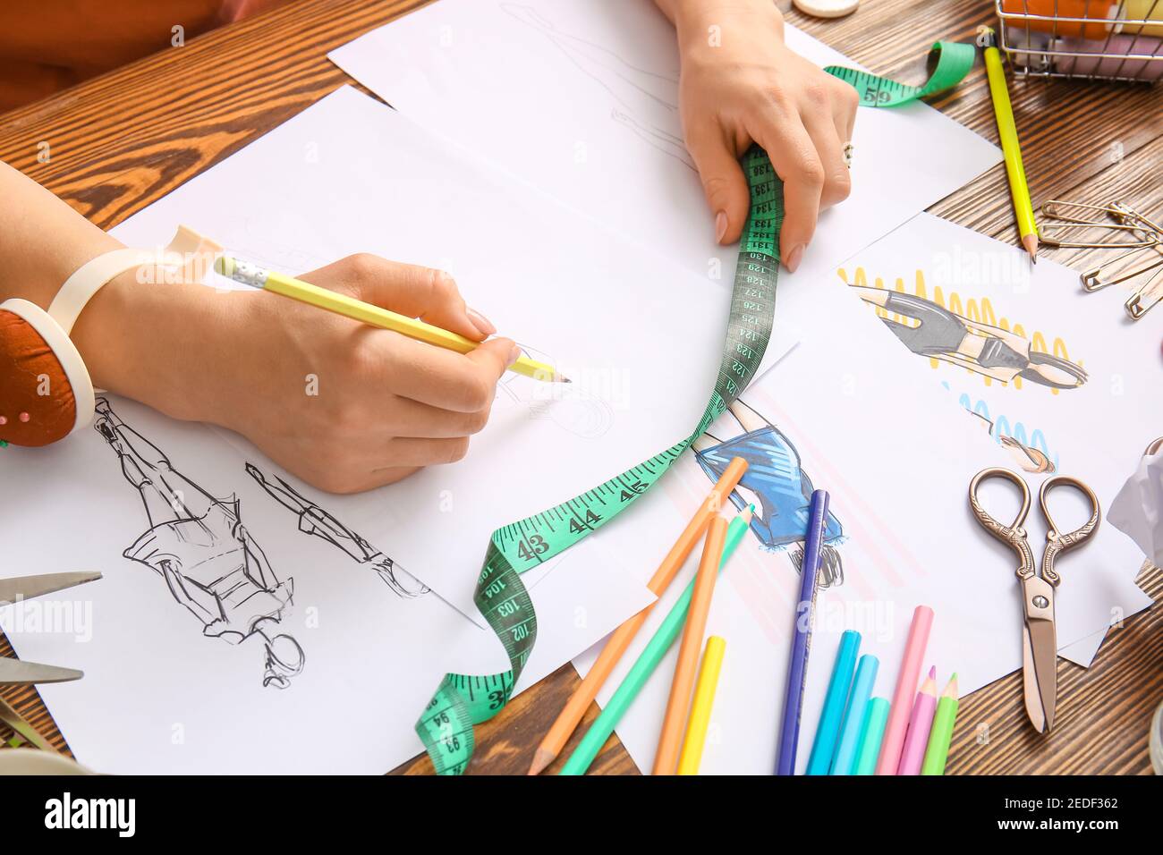 Female fashion designer working with sketches in studio, closeup Stock ...