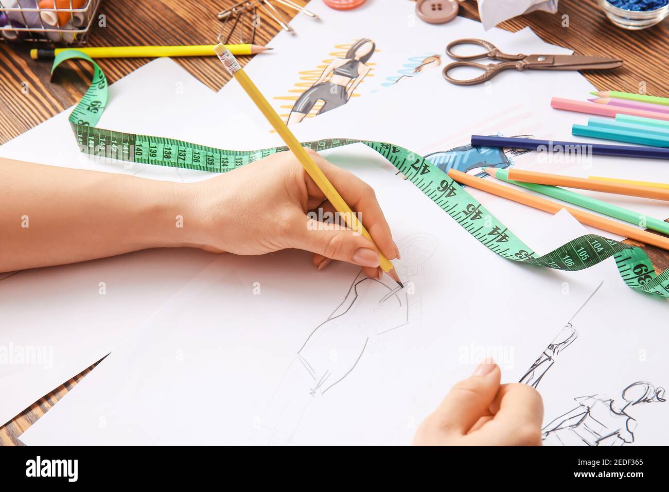 Female fashion designer working with sketches in studio, closeup Stock ...