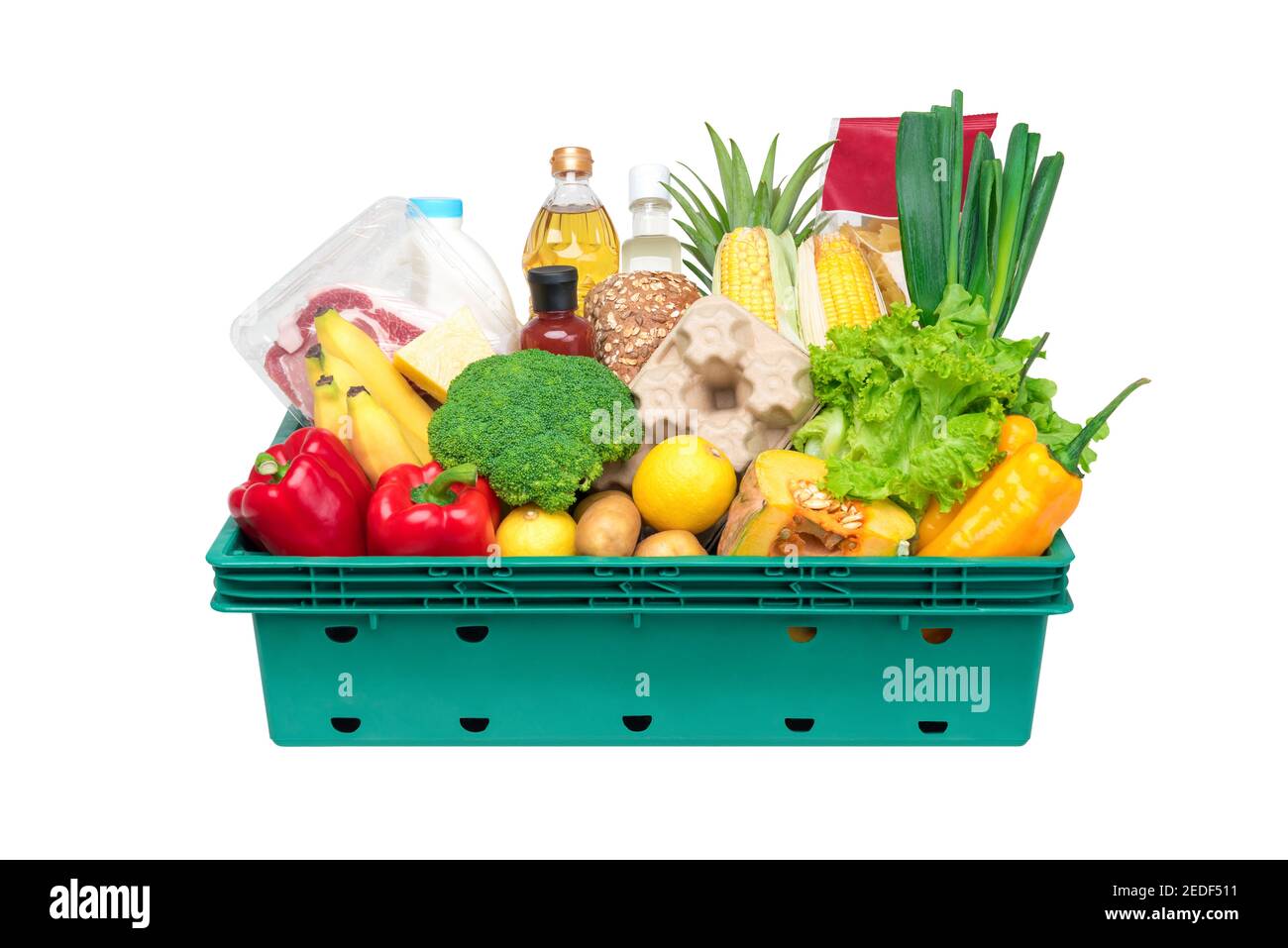 Fresh healthy groceries and vegetables from supermarket in green tray box isolated on white background Stock Photo