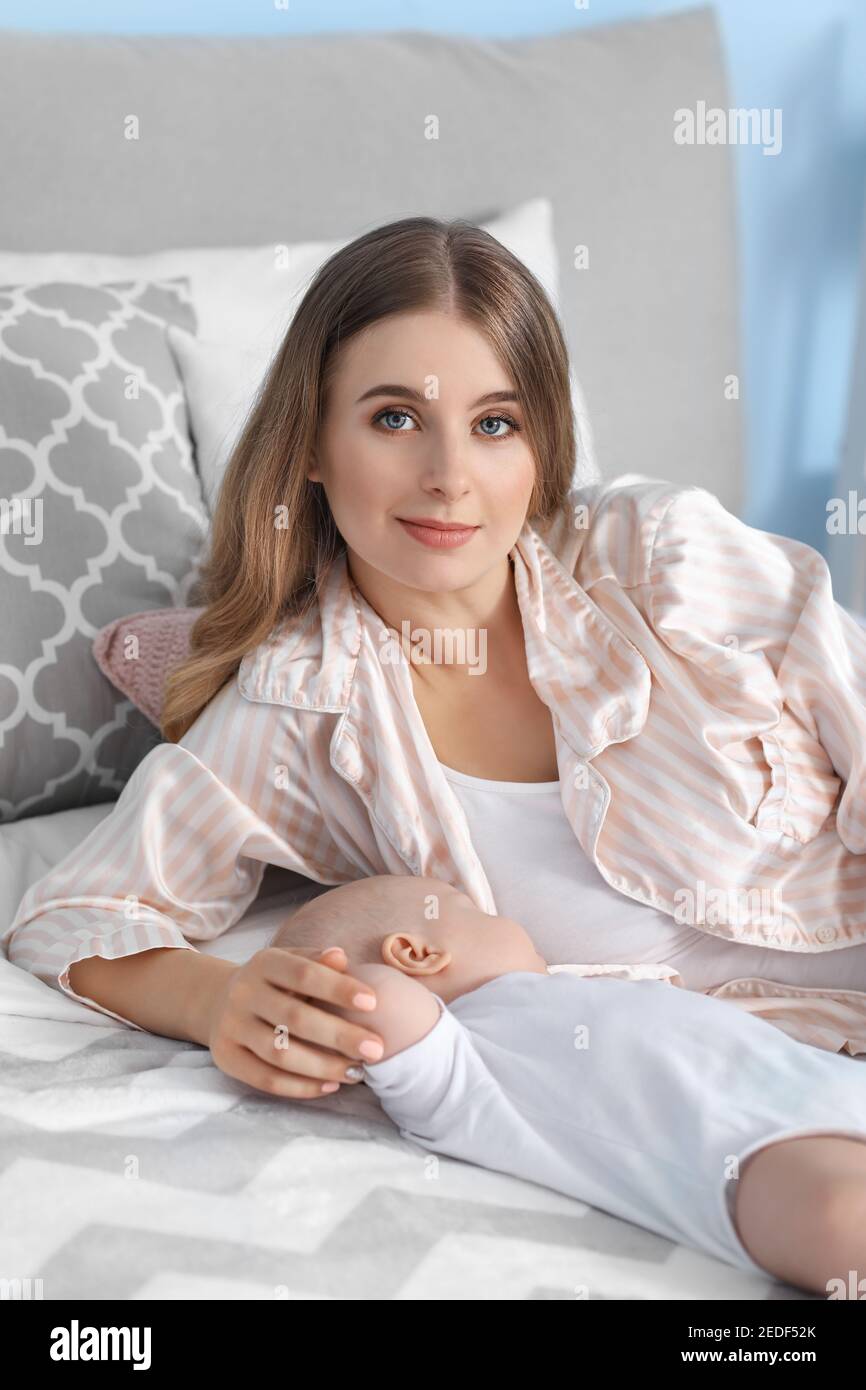 Mother with little baby sleeping on bed at home Stock Photo Alamy