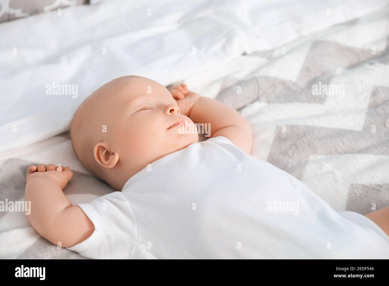 Cute little baby sleeping on bed at home Stock Photo