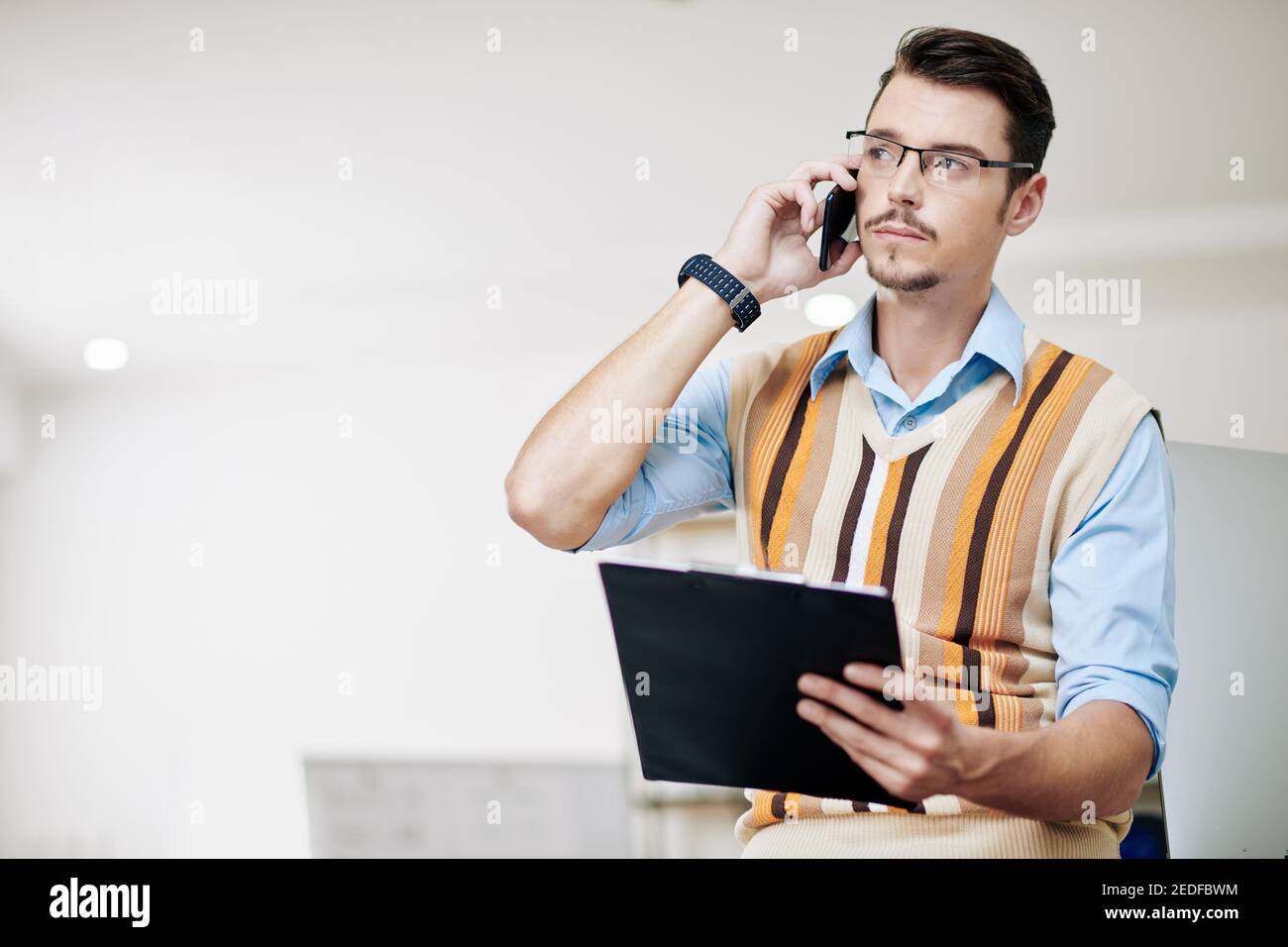 Pensive businessman talking on phone Stock Photo