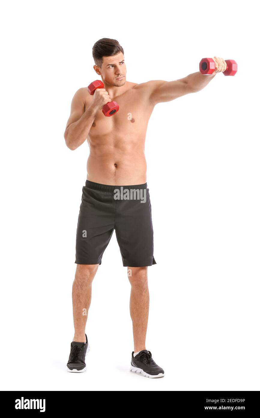 Sporty young man training with dumbbells on white background Stock Photo