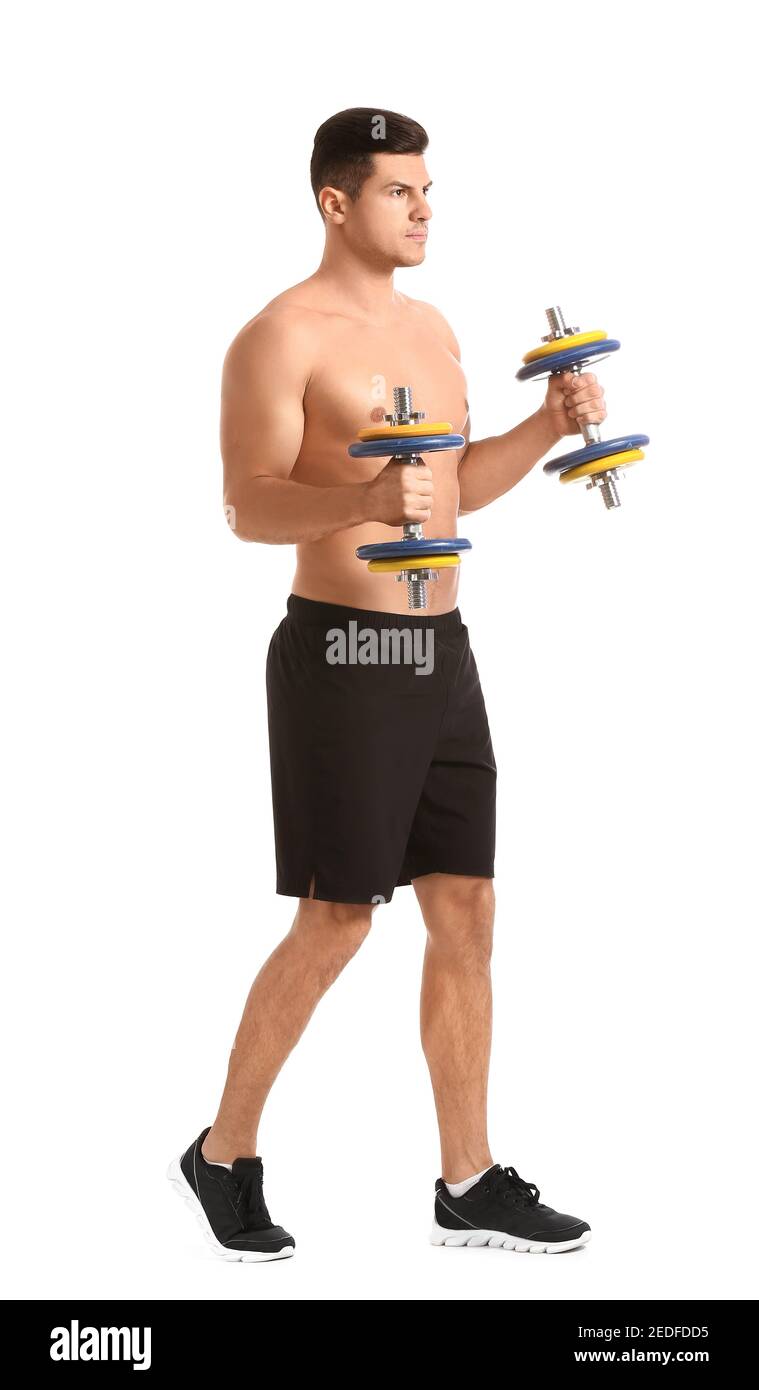 Sporty young man training with dumbbells on white background Stock Photo