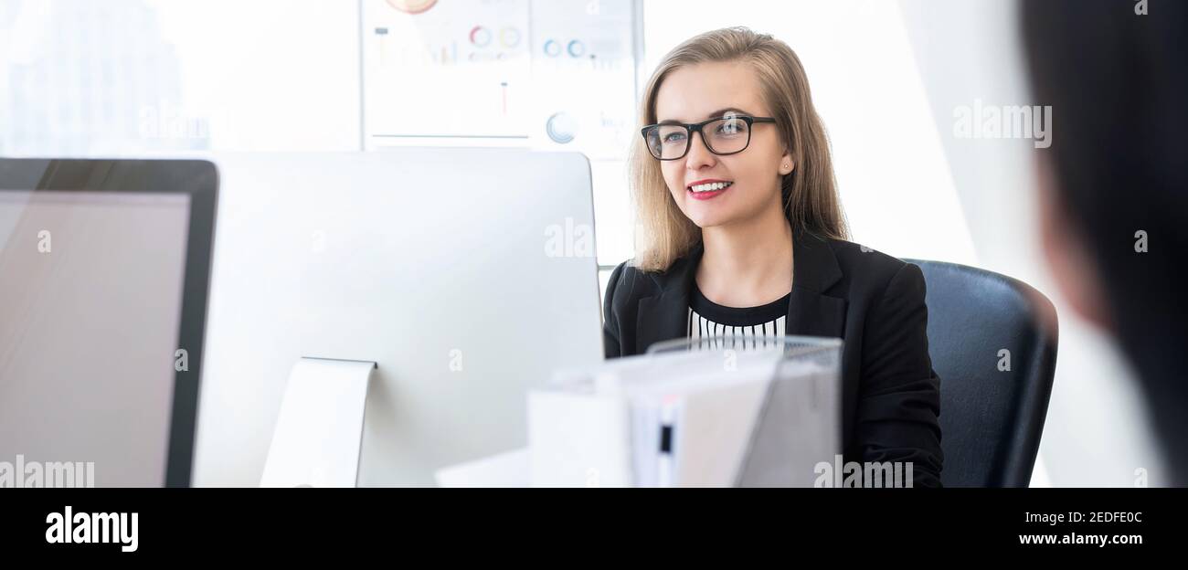 Smiling happy businesswoman white collar worker concentrating on working with desktop computer in office banner background Stock Photo